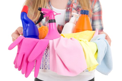 Professional home cleaners preparing a Brixton living room for a regular clean