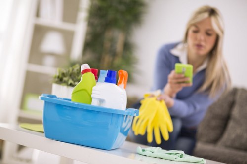 Local cleaner working in a Brixton flat with attention to kitchen surfaces
